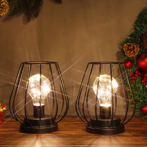 2-pack 7-inch tall black metal battery-operated lamps with cage-style frames and glowing bulbs.