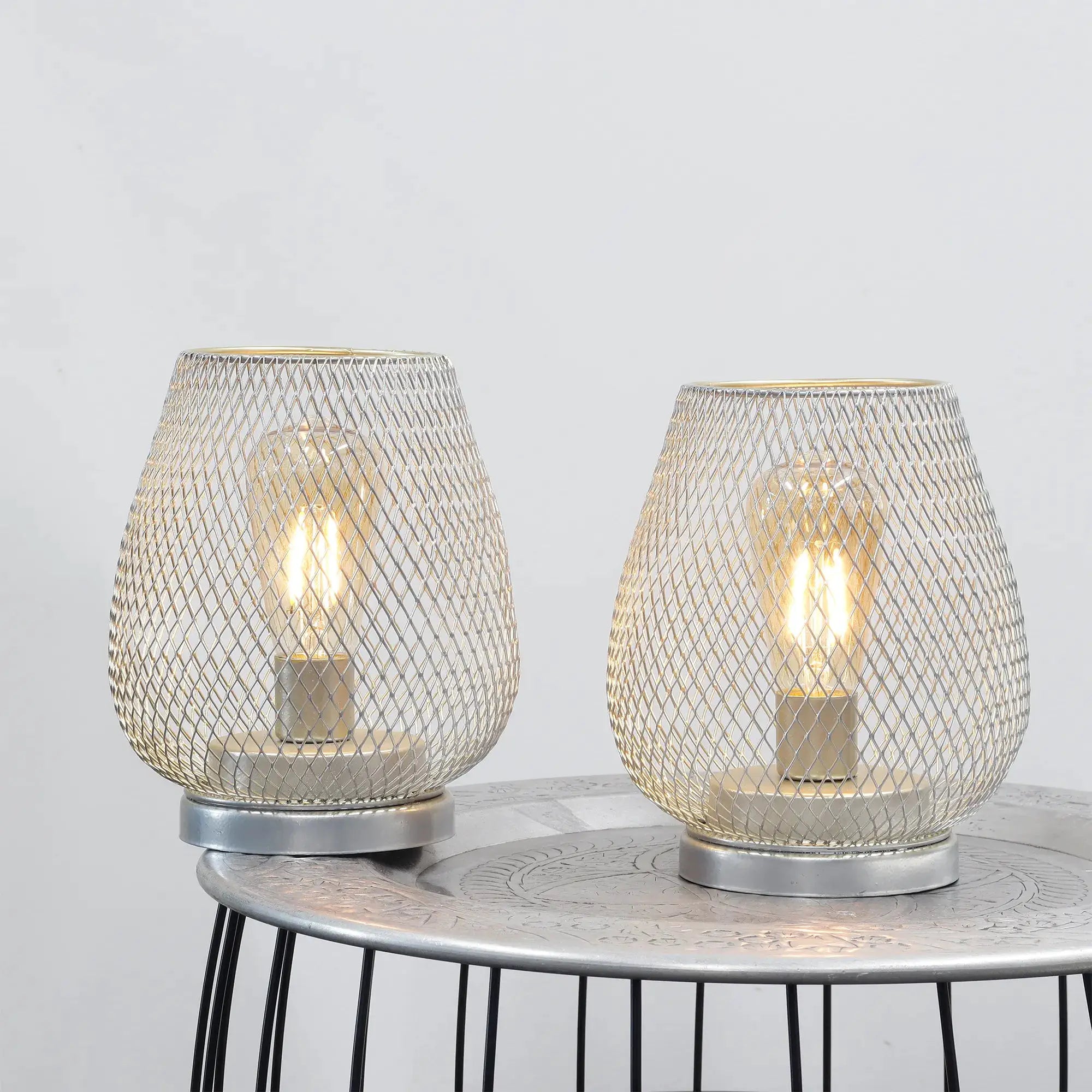 Set of 2 silver metal cage LED lanterns, battery-operated.