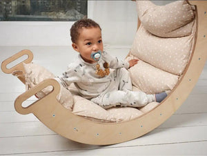 Cushion for Climbing Arch & Rocker Balance by Goodevas; beige soft balance cushion on curved wooden rocker.
