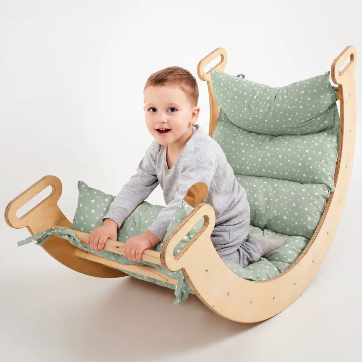 Cushion for climbing arch and rocker balance; green star-pattern fabric, cloud-like padding.