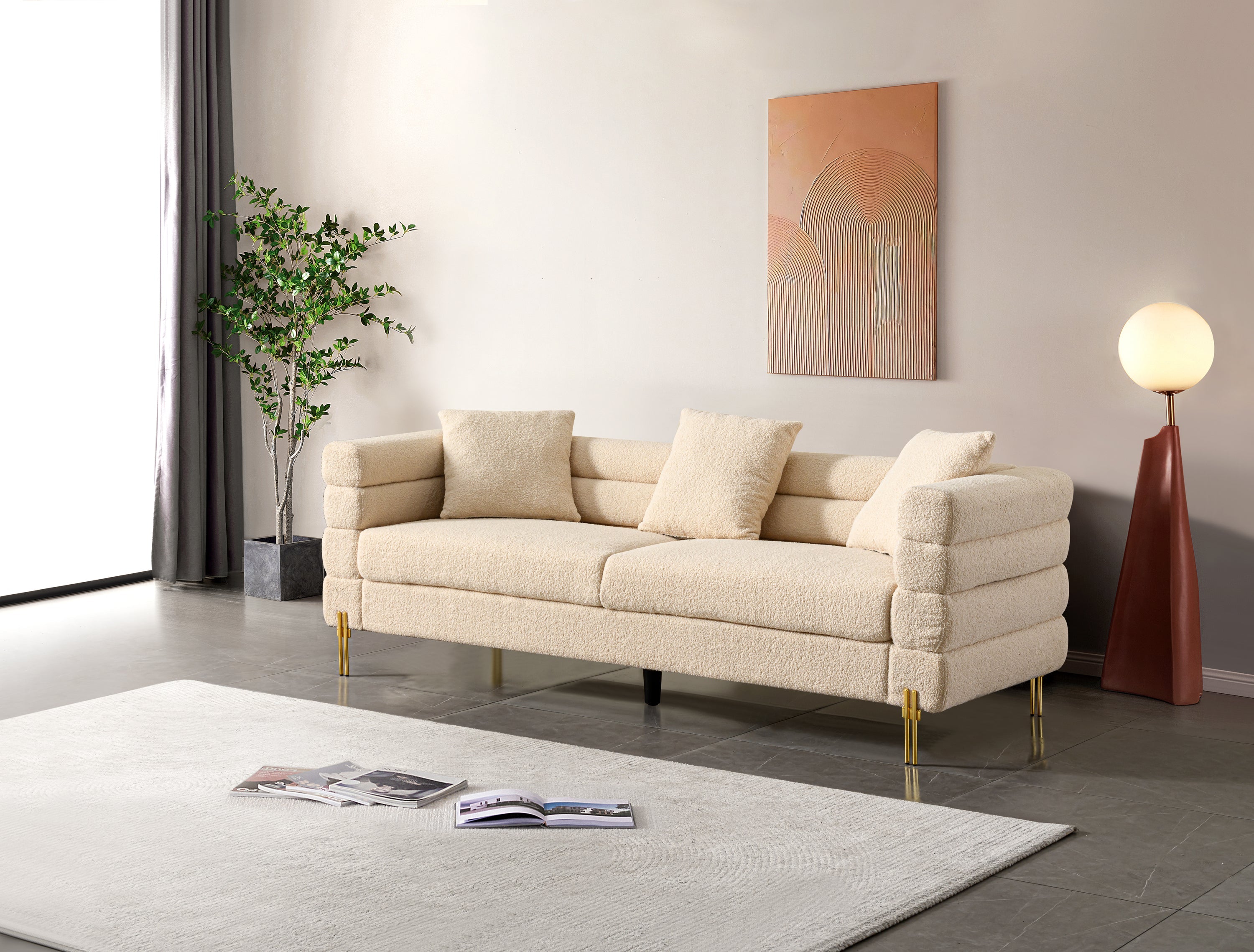 Luxurious and comfortable upholstered sofa with golden legs and pillows for living room and reception area