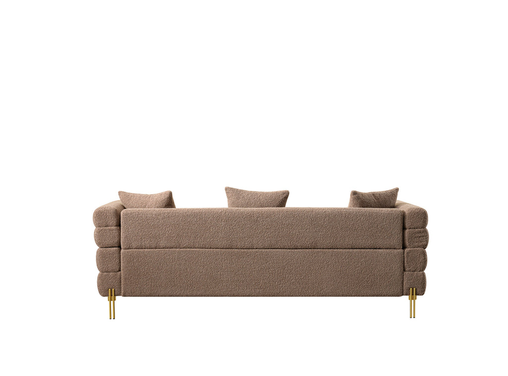 Luxurious and comfortable upholstered sofa with golden legs and pillows for living room and reception area