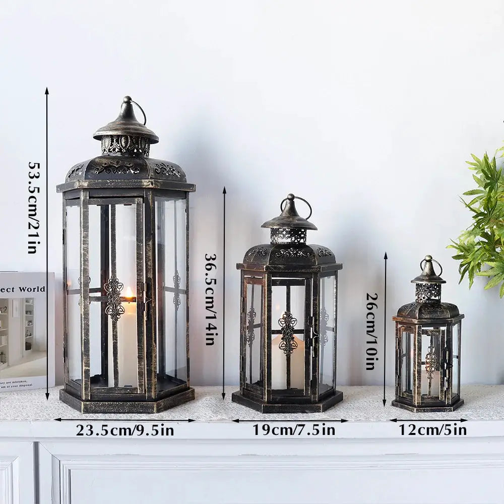 Set of 3 decorative candle lanterns, black with gold brush accents.