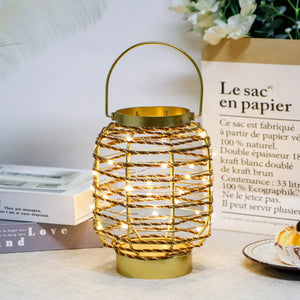 7.7 in H metal cage LED cordless table lamp by JHY DESIGN; gold finish with warm string lights
