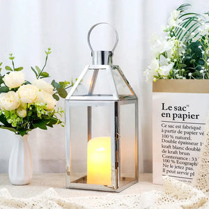 16-inch decorative candle lantern with glass panels and silver metal frame, candle glowing inside