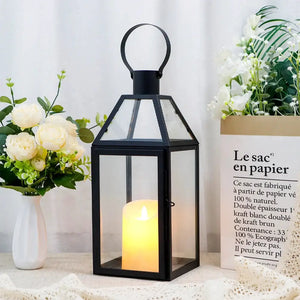 16 inch high black decorative lantern with glass panels and a lit candle inside