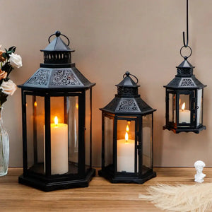Set of 3 black hexagonal decorative candle lanterns (18in, 13in, 10in high) with glass panels and lit candles