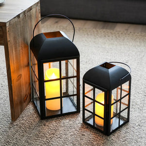 Decorative candle lanterns set of 2 in black metal with glass panels, 10.5 in and 14 in heights.