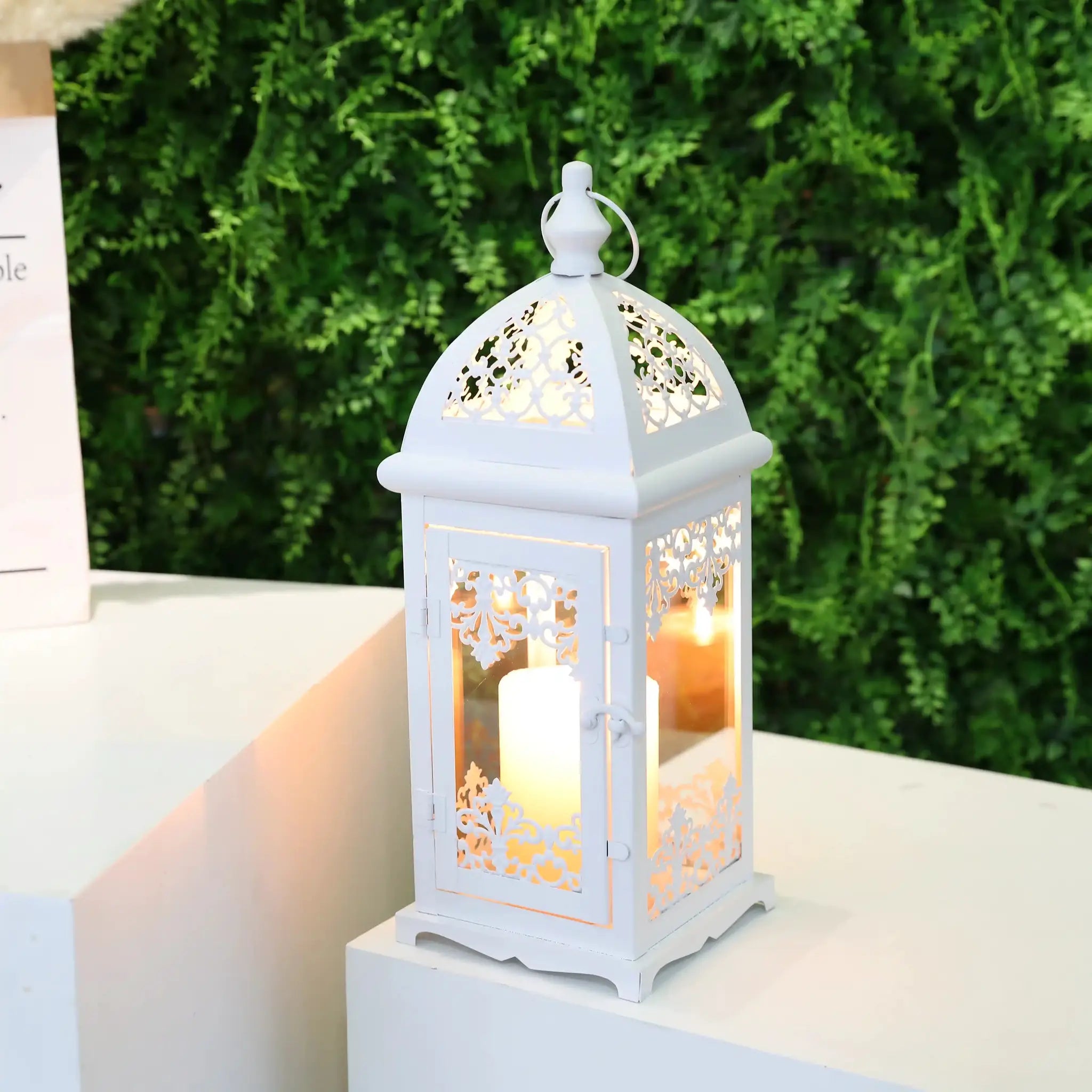 15-inch white decorative candle lantern with ornate floral lattice panels and a lit candle
