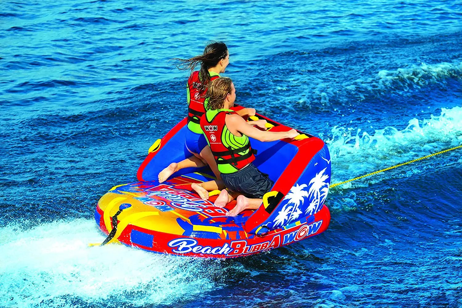 WOW Beach Bubba 2-person towable raft in red, blue, and yellow with palm tree graphics.