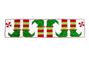 Quilt Kit: Elf Feet Christmas Table Runner by Block Party Quilt Co; red and green elf-foot motifs.