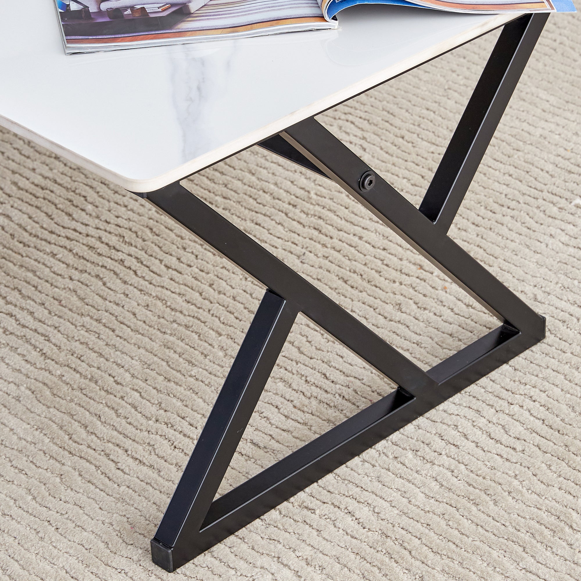 A coffee table made of rock slab material, with a smooth and natural surface that complements the modern design of the black metal legs, making it suitable for living rooms of all sizes.47*23.6