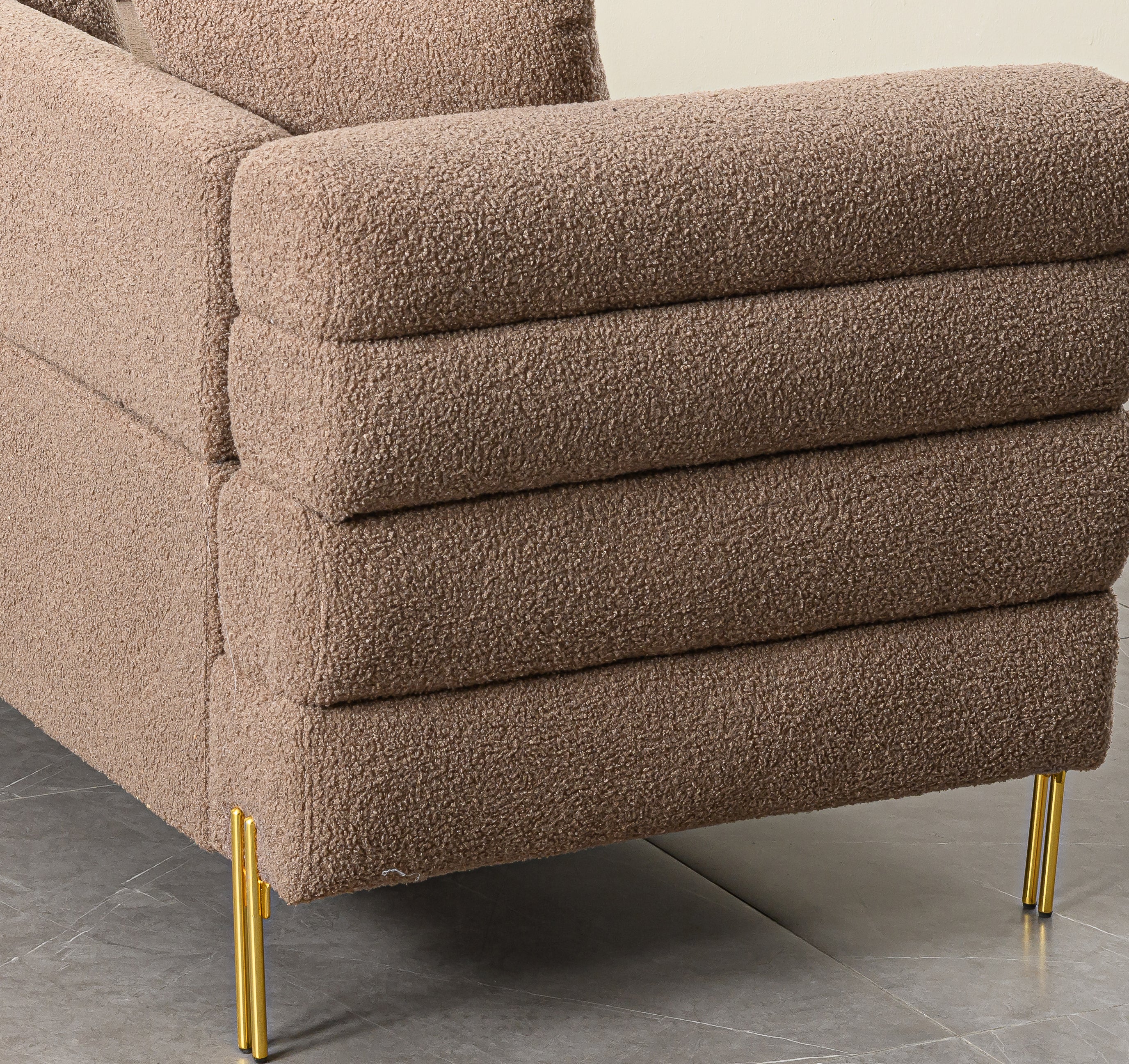 Luxurious and comfortable upholstered sofa with golden legs and pillows for living room and reception area