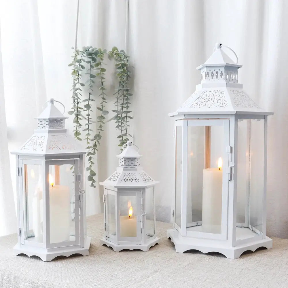 Set of 3 white hexagonal decorative lanterns by JHY DESIGN with etched patterns and candles.