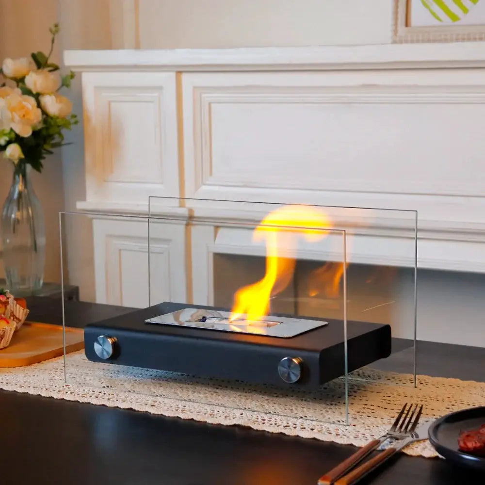 14-inch L portable tabletop fireplace with black metal base and clear glass panels, gel/ethanol flame.