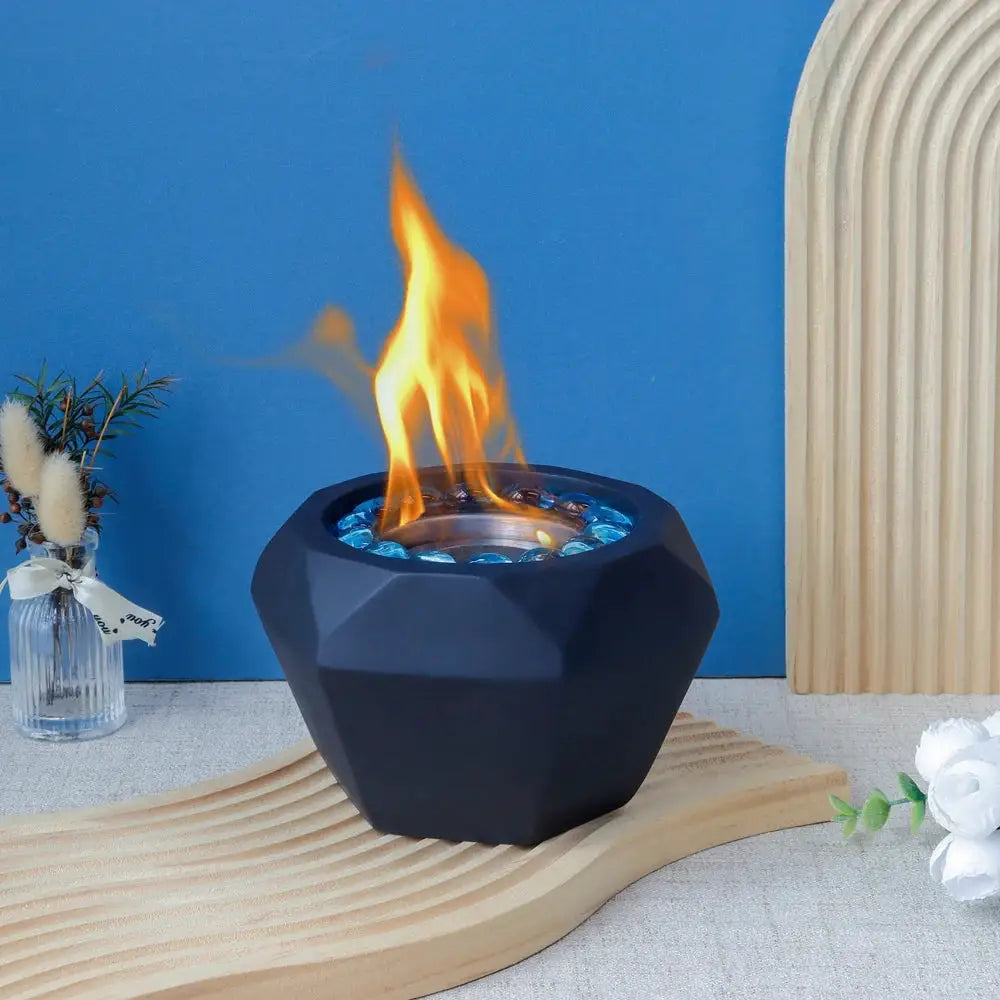 6x4 Portable Cement Tabletop Fireplace with a black cement base and blue glass pebbles