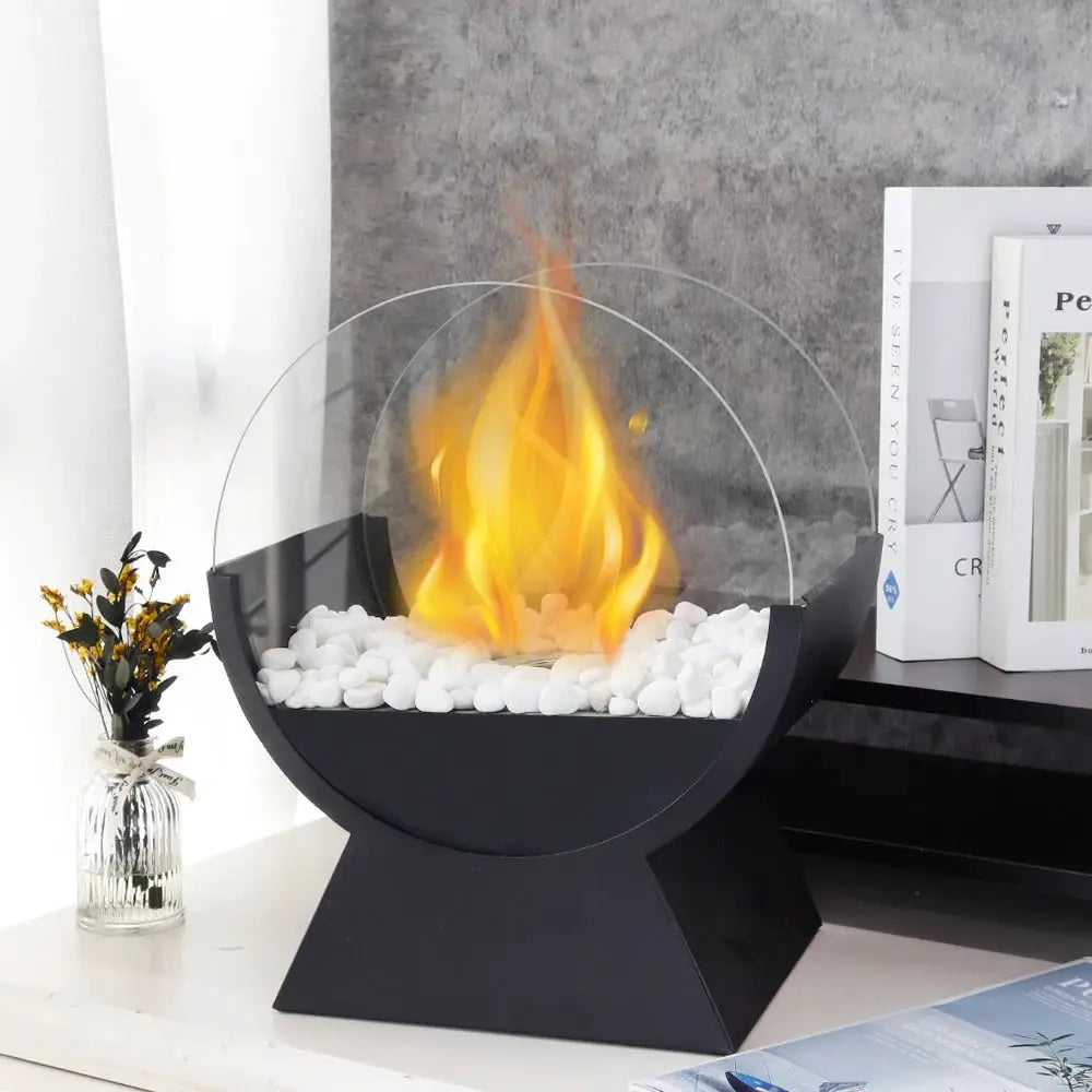 JHY DESIGN portable tabletop fireplace; 13.5-in tall with round glass surround, black base, and white decorative stones.