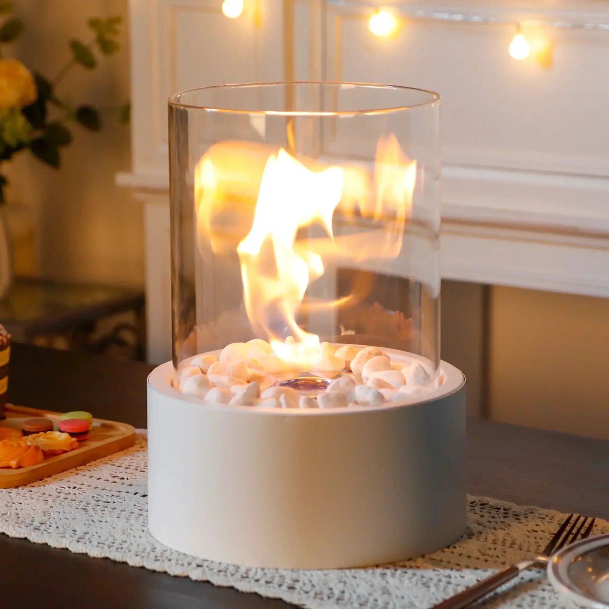 Extra large portable tabletop bio-ethanol fire bowl with clear glass cylinder and pebble base.