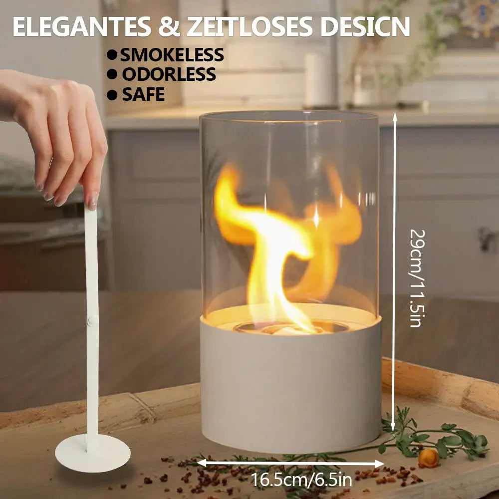 Tabletop fire bowl fireplace with glass cylinder and white base; 11.5in tall, 6.5in diameter.