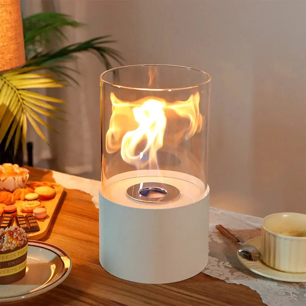 11.5-inch tabletop fire bowl fireplace with white base and clear glass cylinder, flame visible