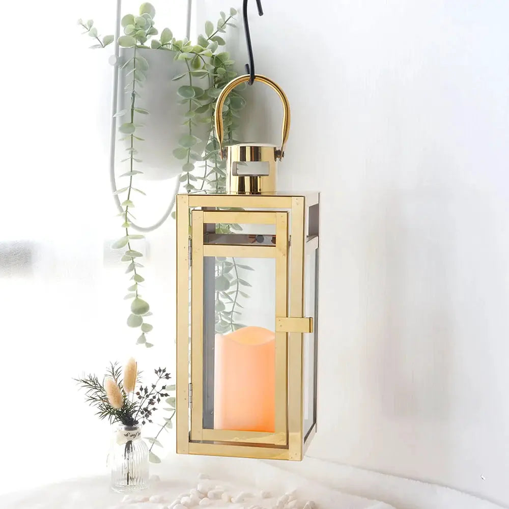 12'' High Metal Decorative Candle Lantern in gold with glass panels and hanging loop.
