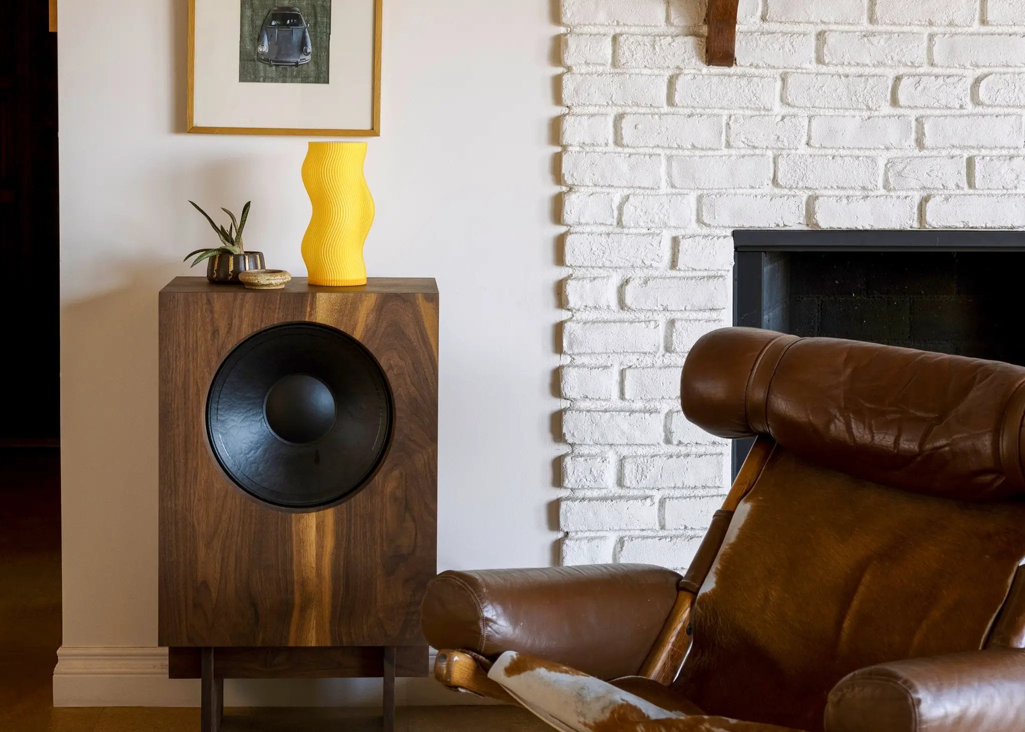 Woogie table lamp by Terra Labs; bright yellow, sculptural wavy design on a wooden console.