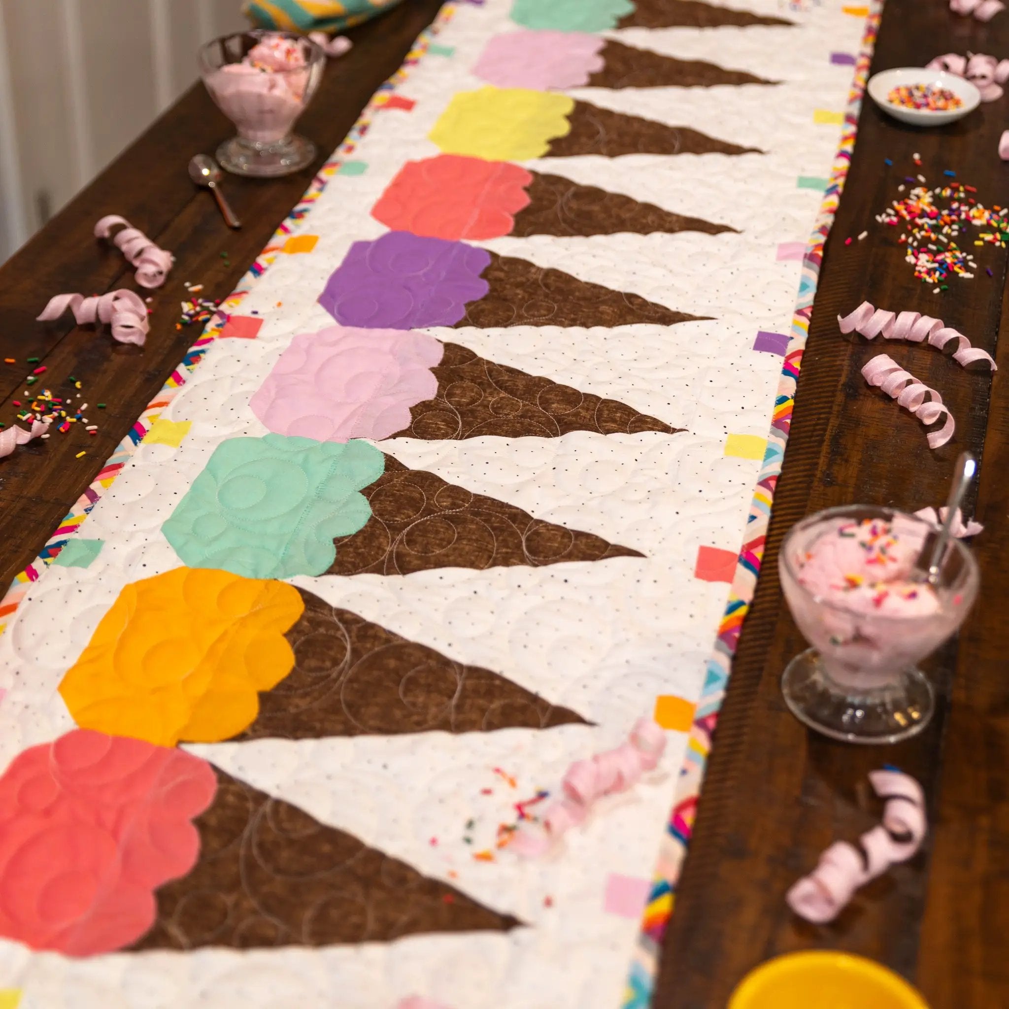 Spring Quilted Table Runner Kit Bundle by Block Party Quilt Co; pastel blocks with brown sashing and rainbow border