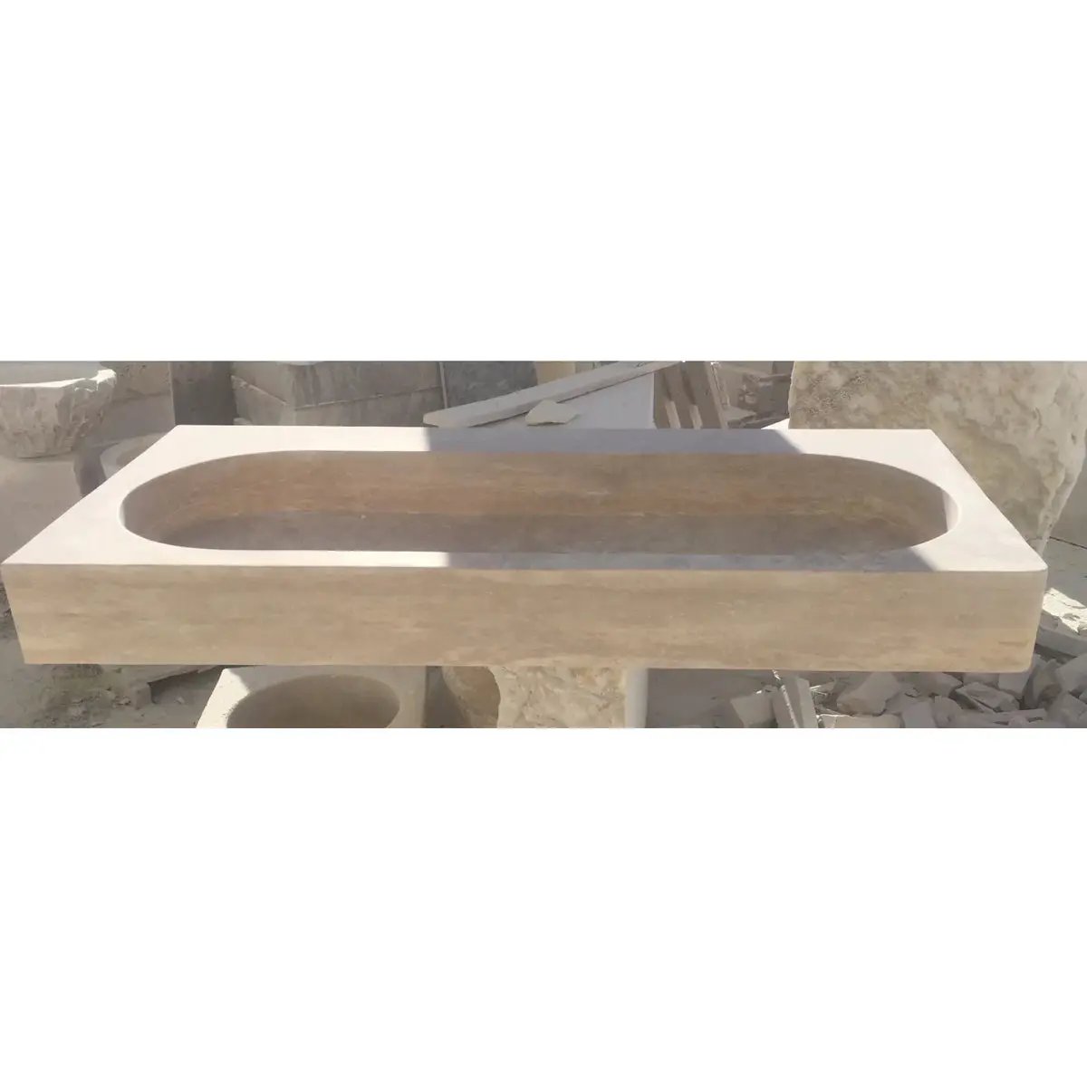 Stone basin sink by Villohome; light travertine natural stone for above-counter vanity