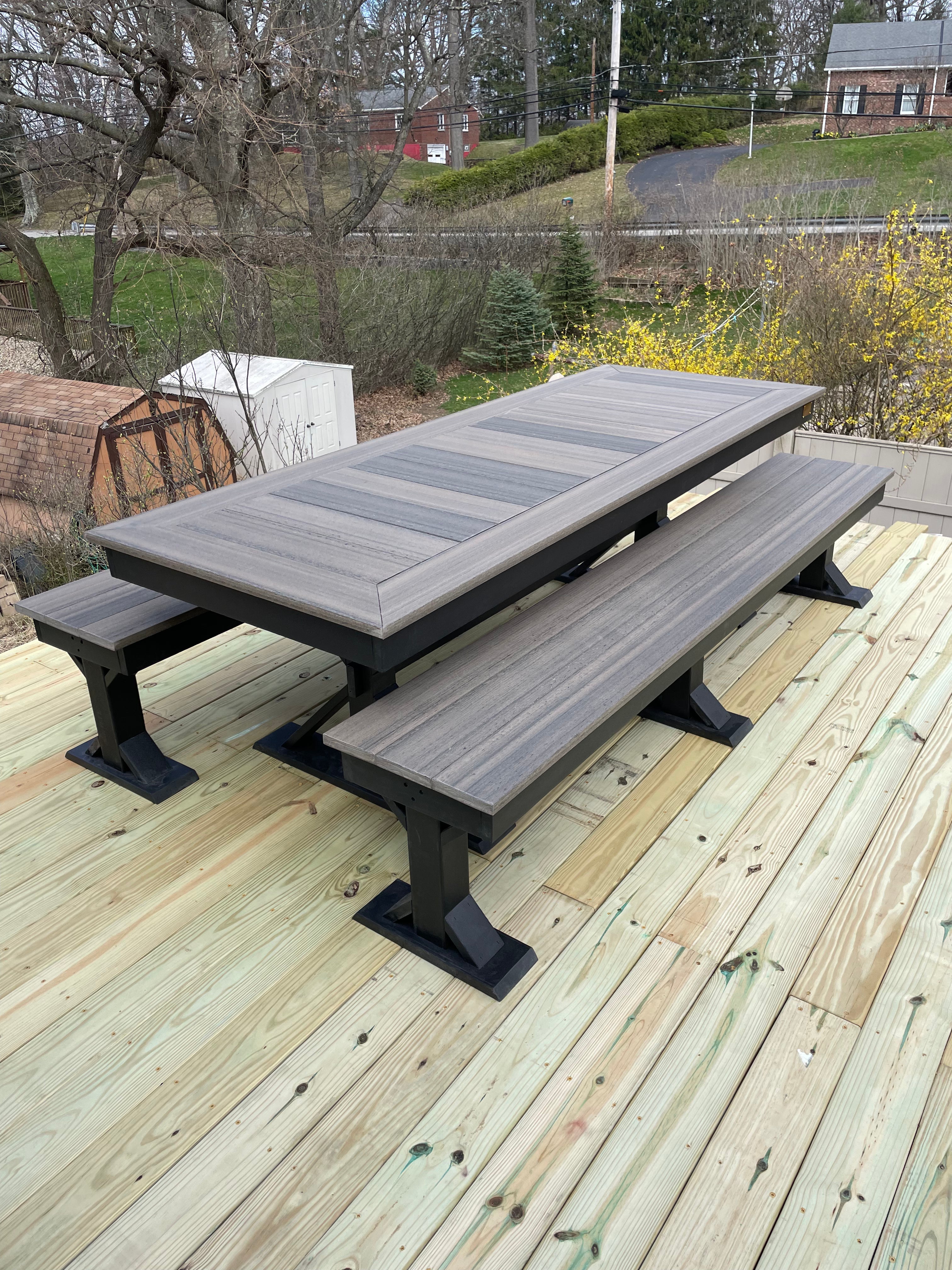 Trestle X Outdoor Bench, gray-stained wooden table with attached benches on black trestle bases.