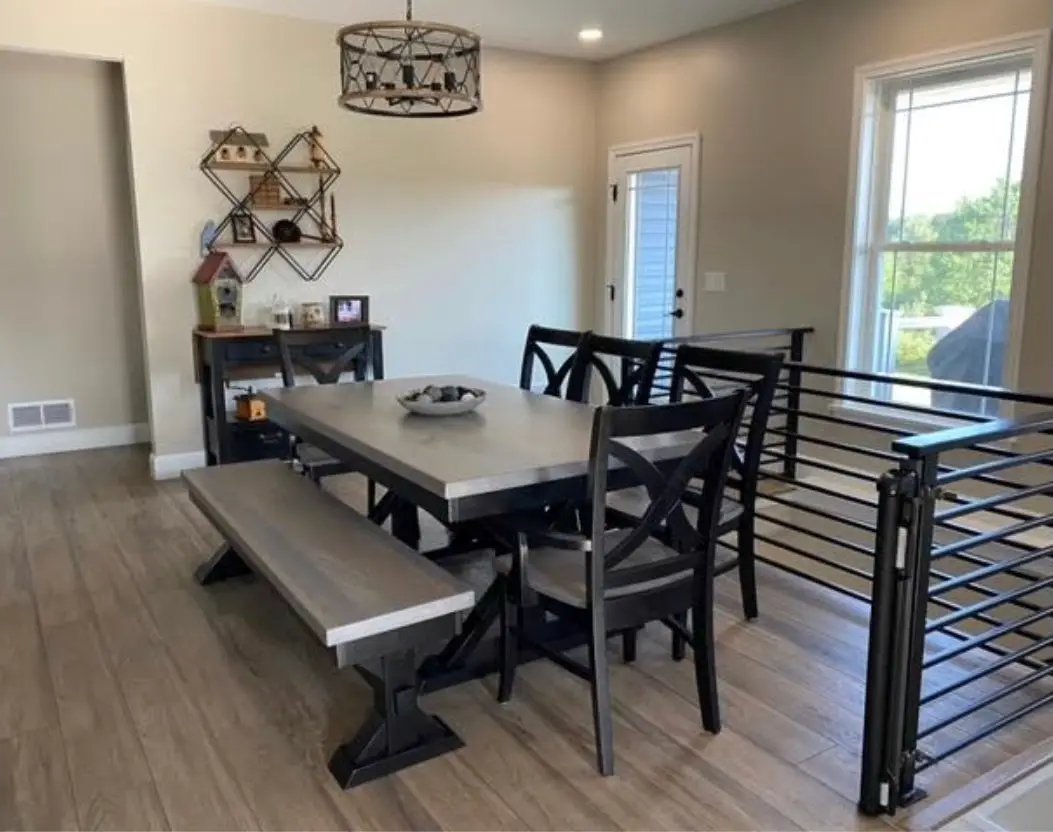 Vineyard Arm Chairs (4) with black metal frames and gray wooden seats around a gray dining table and bench