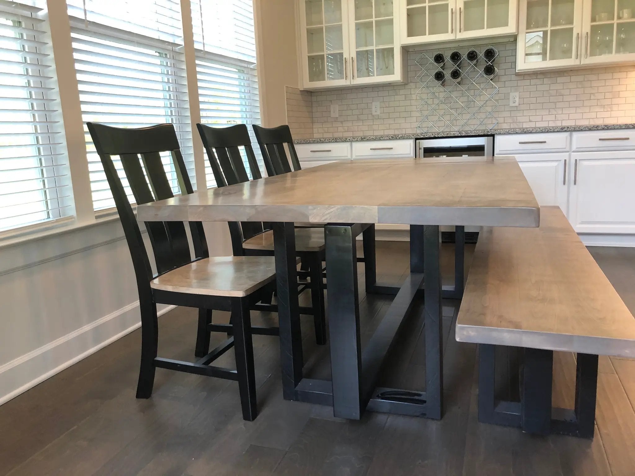 Heston Dinning Table by Wooden Whale Workshop; industrial metal top with black legs in a white kitchen.