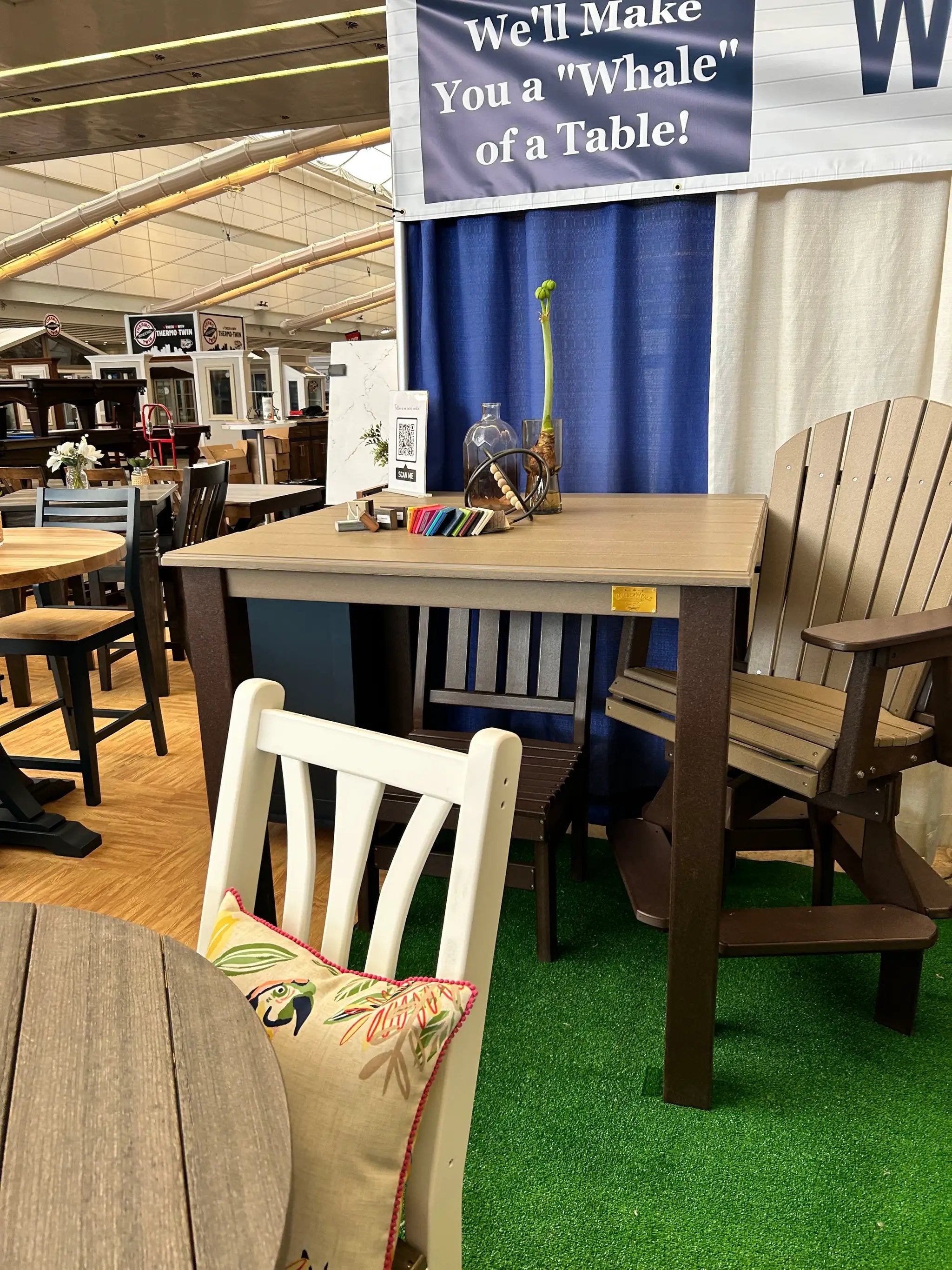 Post Leg Outdoor Counter Height Table with a light tan top and dark brown post legs in an outdoor showroom.