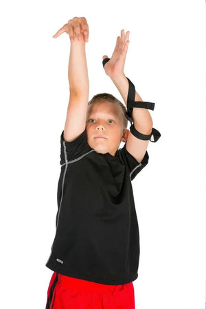 Perfect Jump Shot Strap (Off Hand) by HoopsKing; black arm strap shown on a child wearing a black athletic shirt and red shorts.
