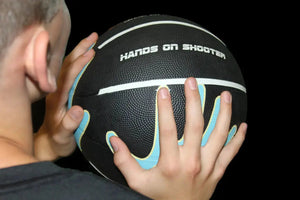 Hands on Shooter basketball training ball with hand-placement grip; black with blue and yellow accents