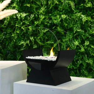 13.5-inch portable tabletop fireplace by JHY DESIGN with a black geometric base, white stones, and circular glass ring