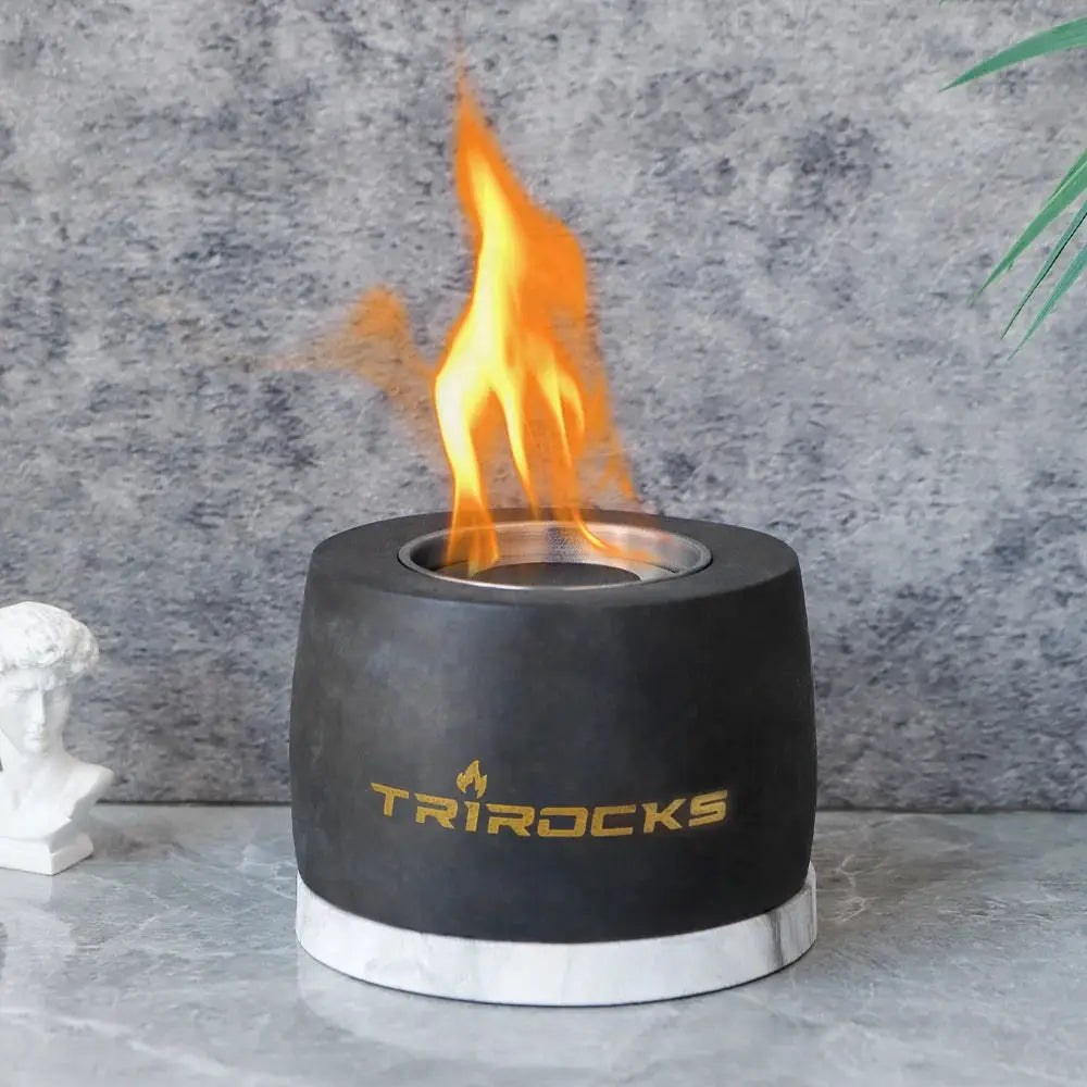 Black graphite cement portable fireplace with flame and Trirocks logo