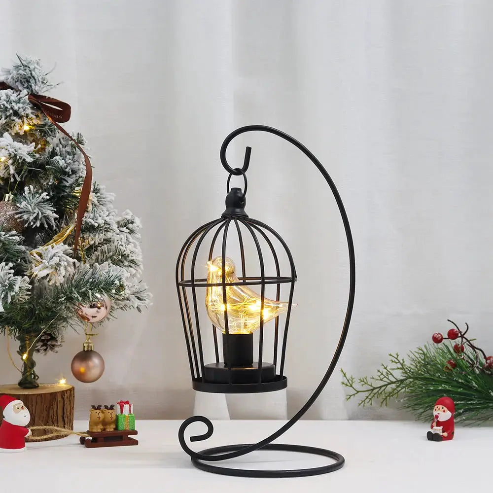 12-inch battery-operated birdcage lamp in black metal with curved stand and warm LED bird glow