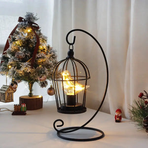 12-inch tall battery-operated birdcage lamp on a curved black stand with warm LED lights
