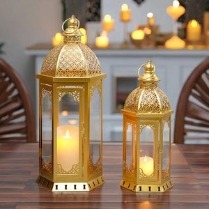 Decorative lanterns, set of 2 metal candle lanterns in gold/brass with intricate lattice panels; 22in and 17in tall.