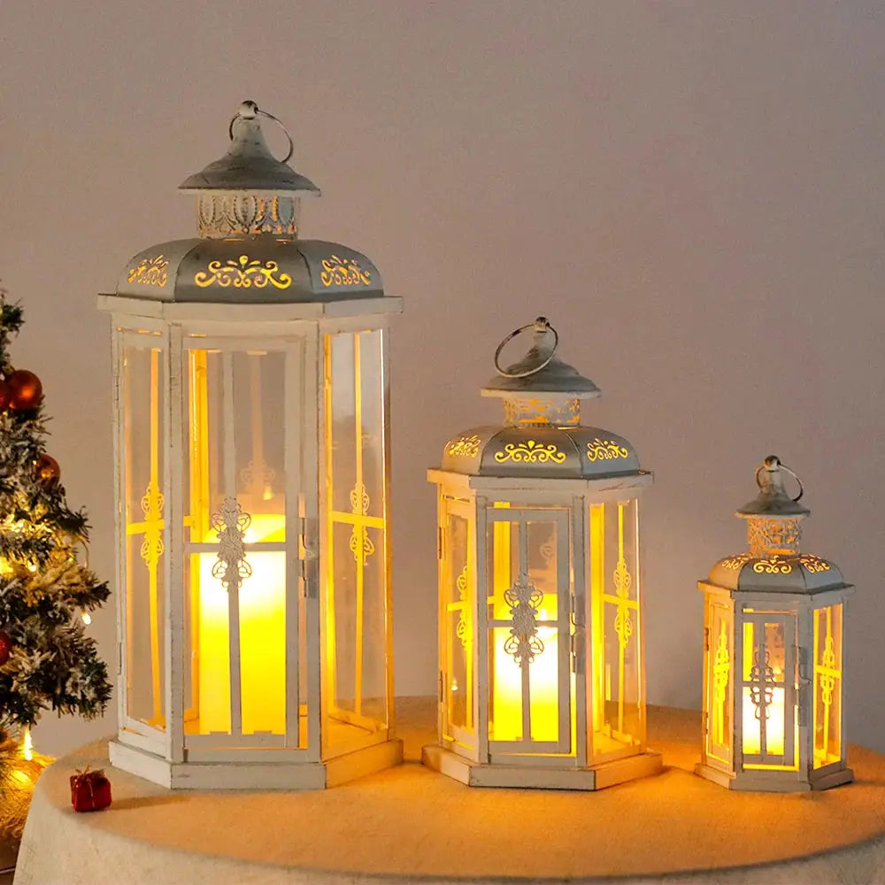 Set of 3 white vintage metal candle lanterns with gold brush detailing; heights 20, 14 and 10 inches