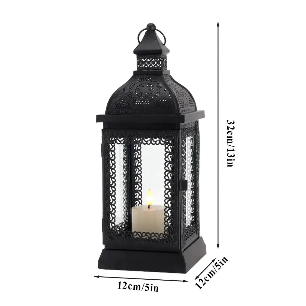 Rustic black metal candle lantern with ornate lattice panels and a candle inside, 13in tall.