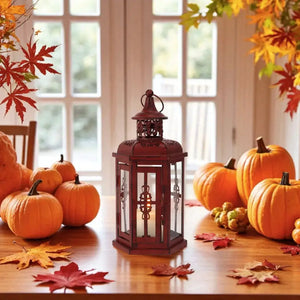 10-inch Vintage Hanging Lantern by JHY DESIGN, red metal decorative candle lantern with glass panels, pumpkins nearby.