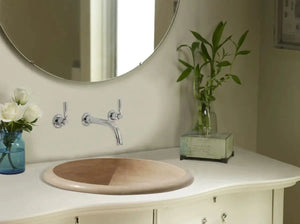 Light beige travertine round stone drop-in bathroom sink with chrome wall-mounted faucet by Villohome