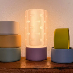 Liunk table lamp, set of 3: ribbed white shade on purple base, beige shade on blue base, lime shade on gray base.