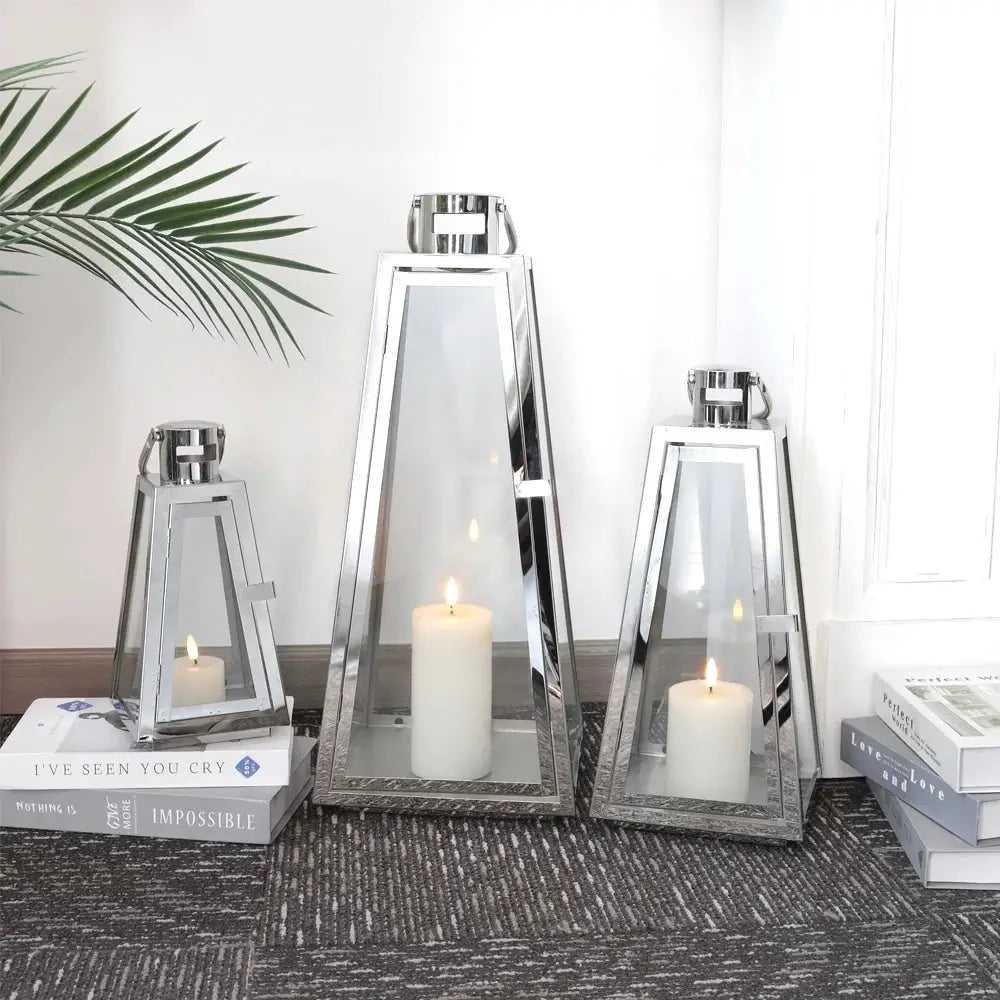 JHY DESIGN 3-piece chrome stainless steel lantern set with glass panels; 21", 16", 11" tall with candles.