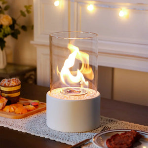 10.5-inch tall table-top fire bowl fireplace; clear glass cylinder with bioethanol flame on a pale blue base