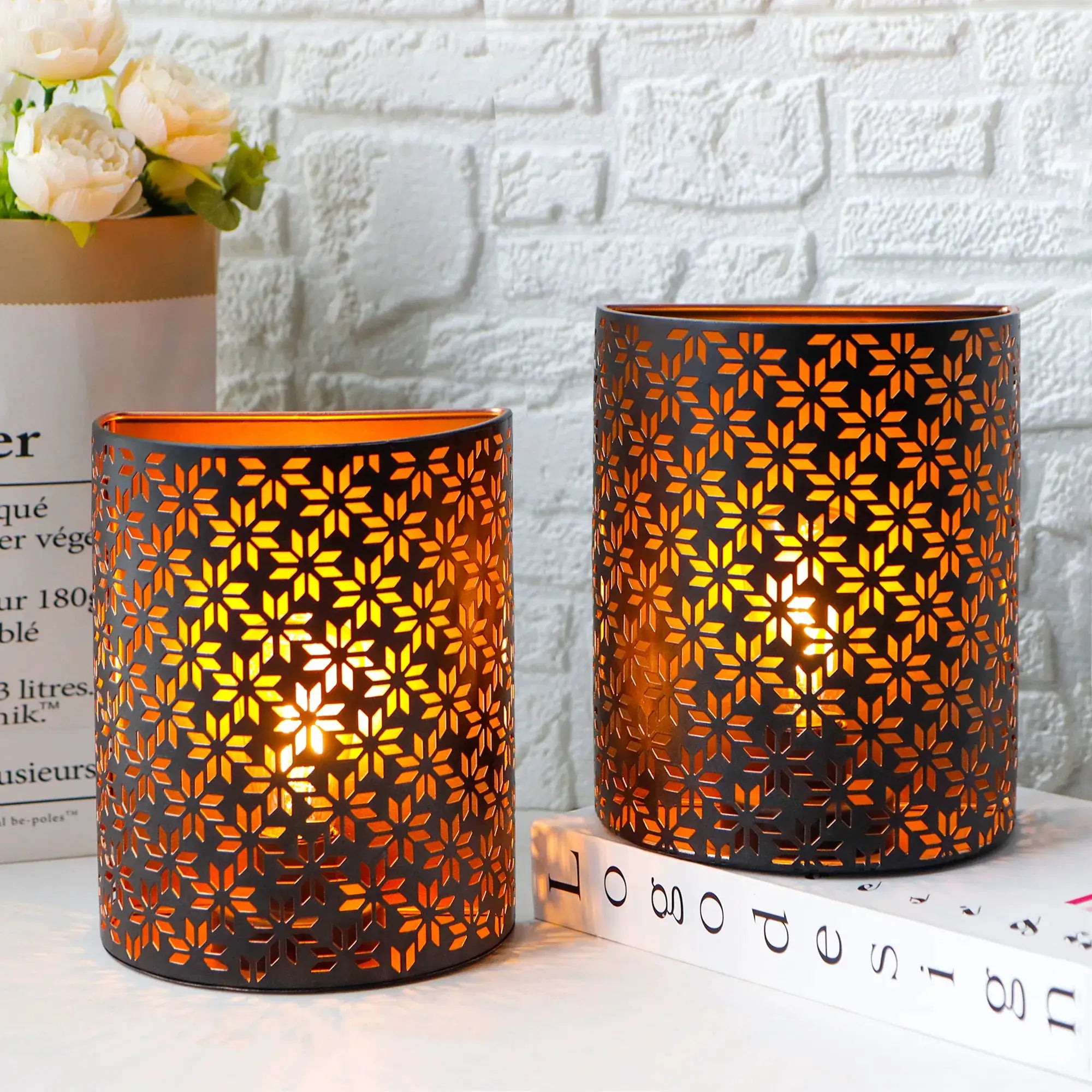 Set of 2 battery-operated wall sconces with dark metal snowflake-pattern cutouts, 8 in tall, warm amber glow.