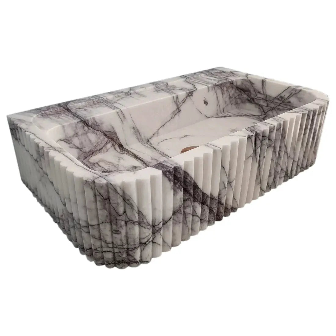 New York Marble wall-mount vessel sink with ribbed textured exterior in white marble with dark veining.