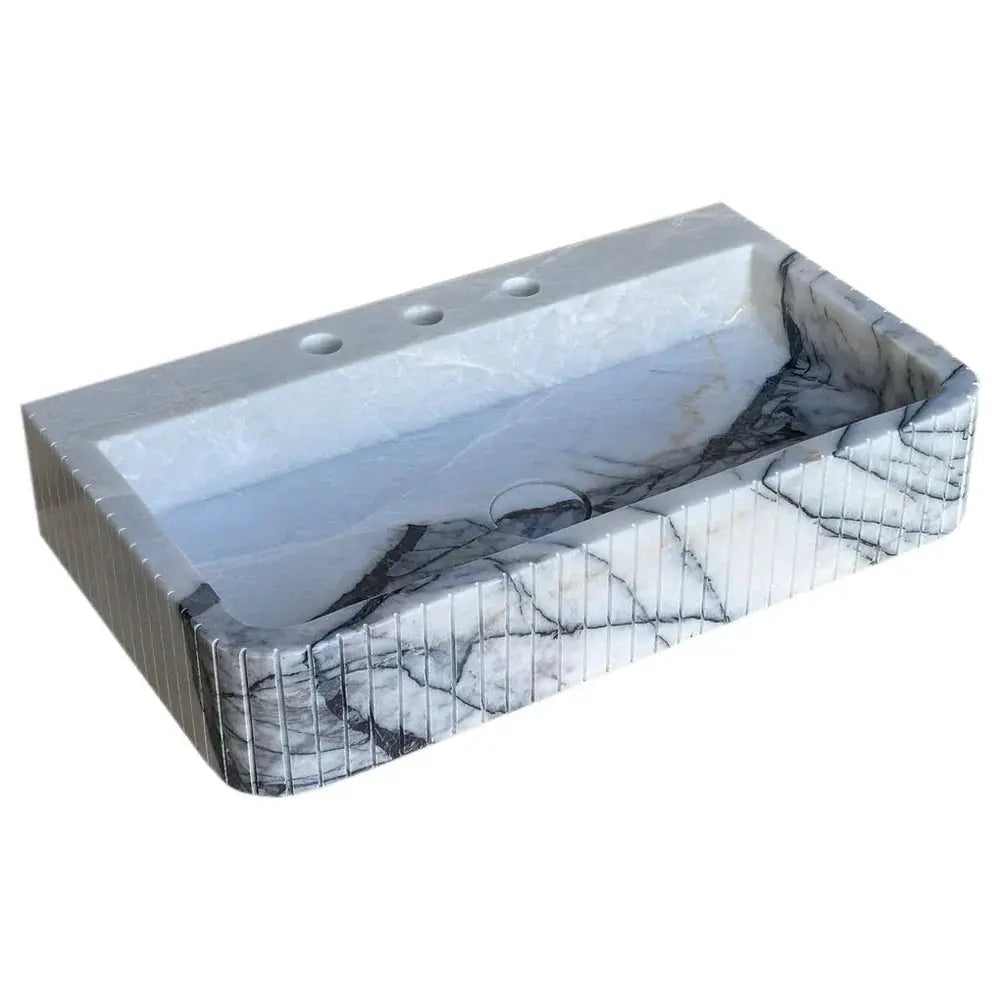 New York Marble wall-mount bathroom sink with fluted front in white with gray veining.