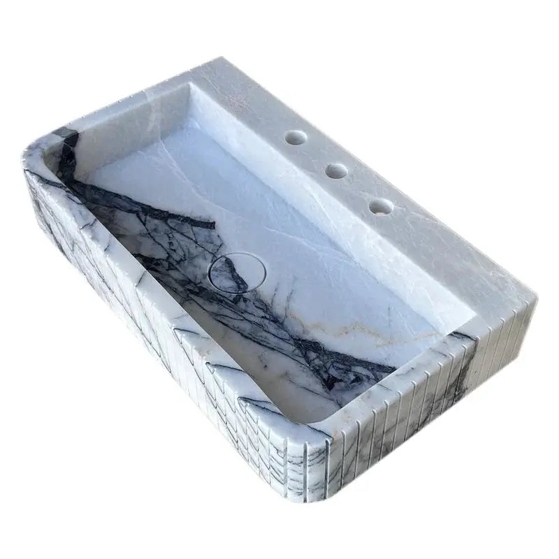 New York Marble wall-mount bathroom sink with fluted front and edges; white marble with gray veining.